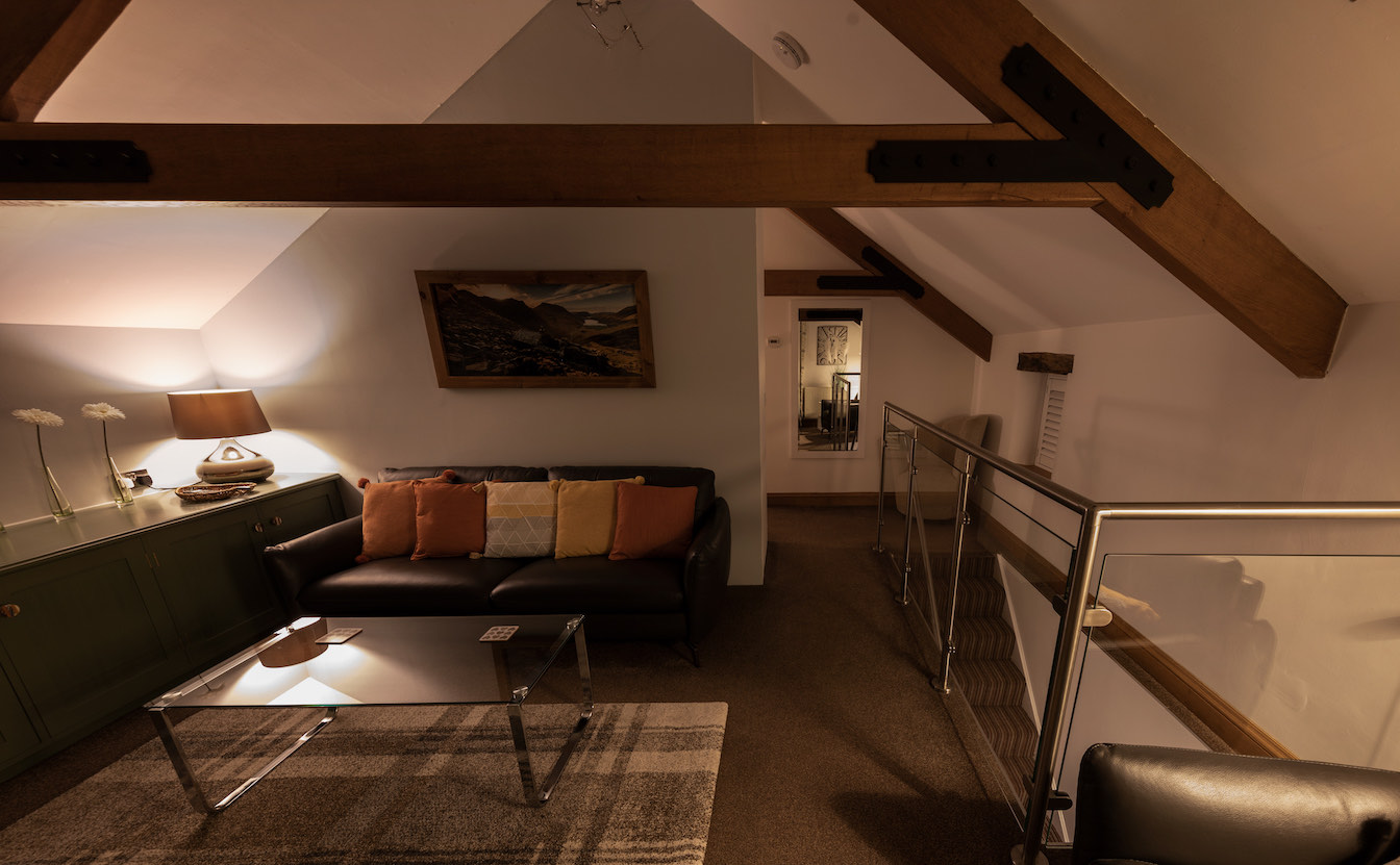 26 Townfoot Barn, Troutbeck - Lake District, Dog-friendly holiday cottage - Lounge vaulted ceiling in the evening-sqz